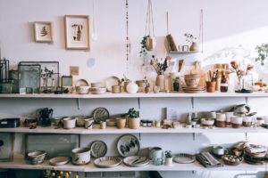 assorted ceramics on wooden shelves